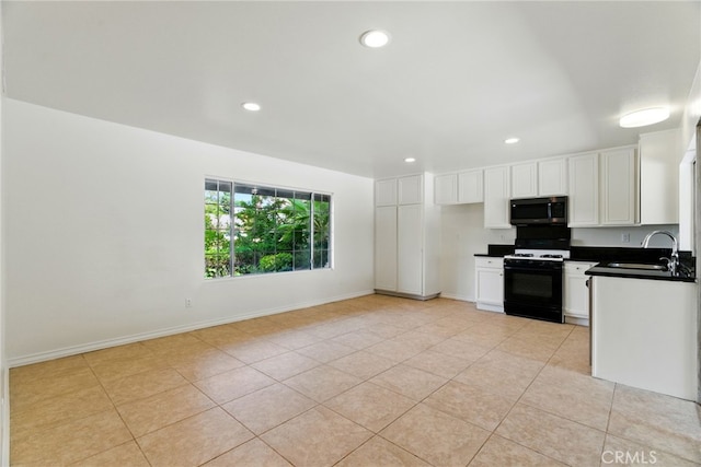 11340 Reseda Blvd, Porter Ranch, CA 91326 - kitchen with gas stove, stainless steel microwave, a sink, dark countertops, and light tile patterned flooring