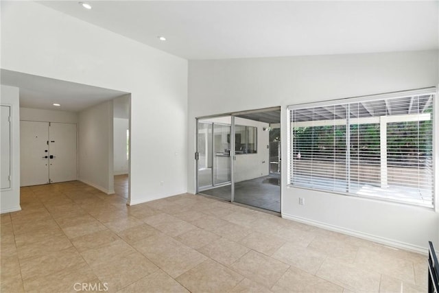 11340 Reseda Blvd, Porter Ranch, CA 91326 - empty room featuring baseboards, recessed lighting, vaulted ceiling, and light tile patterned floors