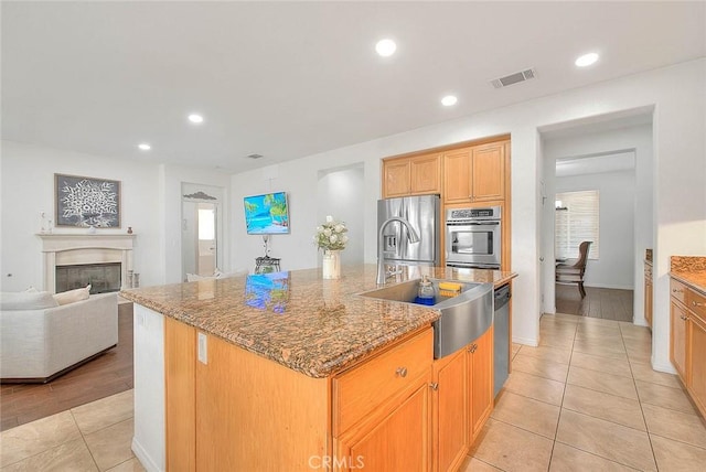 4451 Terry St, Chino, CA 91710 - kitchen with stainless steel appliances, light tile patterned floors, a sink, stone countertops, and recessed lighting