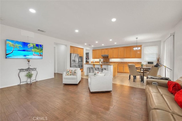 4451 Terry St, Chino, CA 91710 - living area featuring light wood-type flooring and recessed lighting