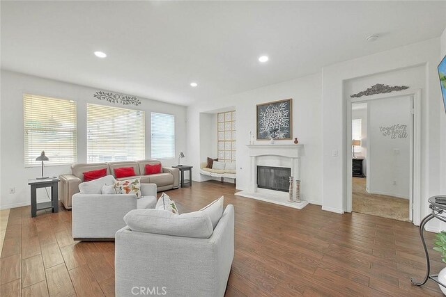 4451 Terry St, Chino, CA 91710 - living area with a glass covered fireplace, wood finished floors, recessed lighting, and baseboards