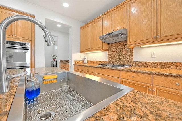 4451 Terry St, Chino, CA 91710 - kitchen with under cabinet range hood, stainless steel appliances, backsplash, recessed lighting, and light stone counters