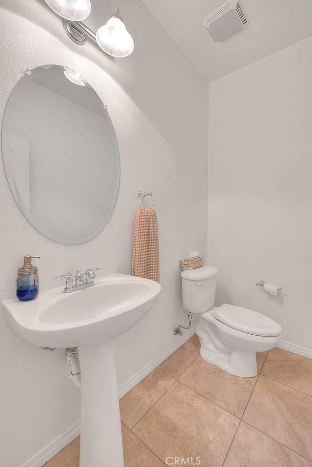 4451 Terry St, Chino, CA 91710 - bathroom with tile patterned floors, toilet, baseboards, and a sink