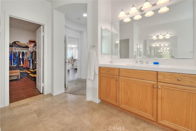 4451 Terry St, Chino, CA 91710 - full bathroom with vanity, a spacious closet, and baseboards