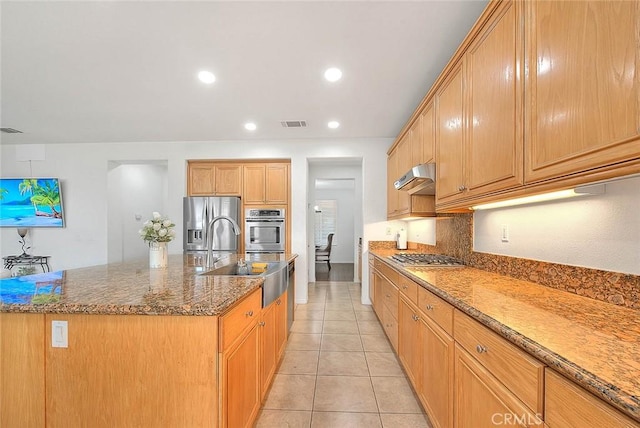 4451 Terry St, Chino, CA 91710 - kitchen with appliances with stainless steel finishes, under cabinet range hood, a sink, an island with sink, and dark stone counters