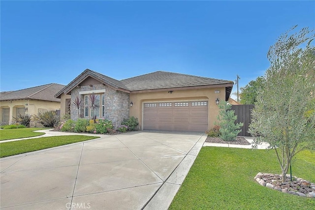 4451 Terry St, Chino, CA 91710 - view of front of property with concrete driveway, stone siding, stucco siding, an attached garage, and a tile roof