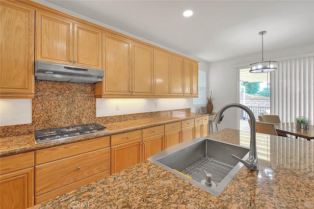 4451 Terry St, Chino, CA 91710 - kitchen with under cabinet range hood, a sink, backsplash, stainless steel gas stovetop, and pendant lighting
