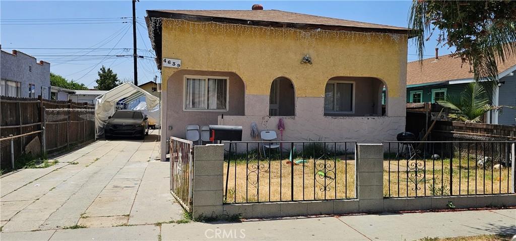 4639 Pine St, Pico Rivera, CA 90660 - view of front facade featuring stucco siding, driveway, and a fenced front yard
