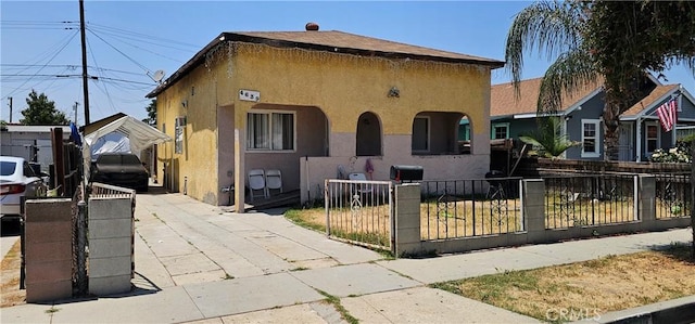 4639 Pine St, Pico Rivera, CA 90660 - view of front of home with stucco siding and a fenced front yard