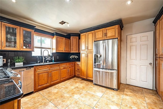 4639 Pine St, Pico Rivera, CA 90660 - kitchen featuring appliances with stainless steel finishes, backsplash, brown cabinetry, light tile patterned floors, and recessed lighting
