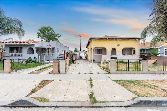 4639 Pine St, Pico Rivera, CA 90660 - mediterranean / spanish home featuring stucco siding, a fenced front yard, and a gate