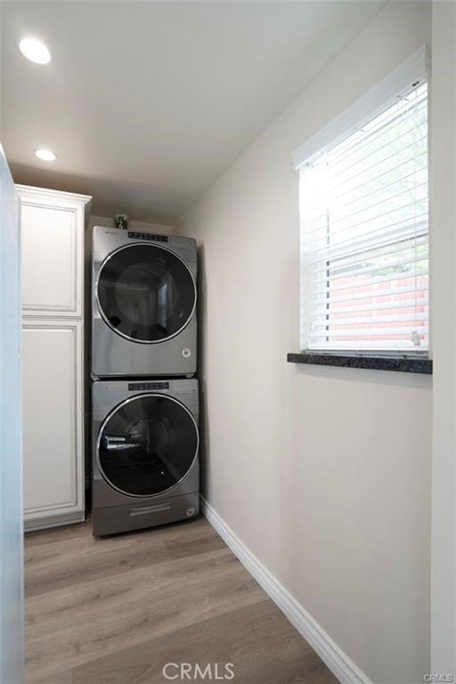 5919 Cantaloupe Ave, Valley Glen, CA 91401 - laundry area featuring stacked washer and clothes dryer, recessed lighting, and light wood finished floors