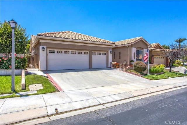 2012 Melbourne Cir, Banning, CA 92220 - view of front of property with an attached garage, concrete driveway, stucco siding, and a tile roof
