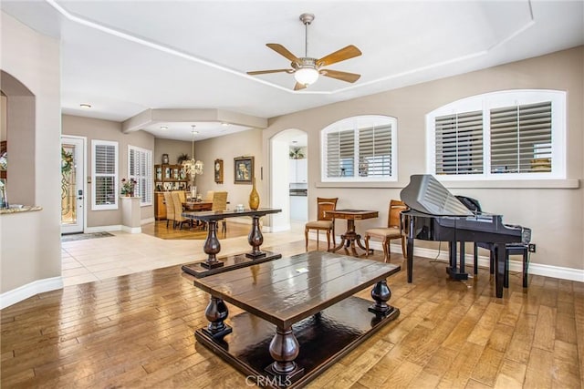 2012 Melbourne Cir, Banning, CA 92220 - living area with arched walkways, light wood-type flooring, baseboards, and ceiling fan