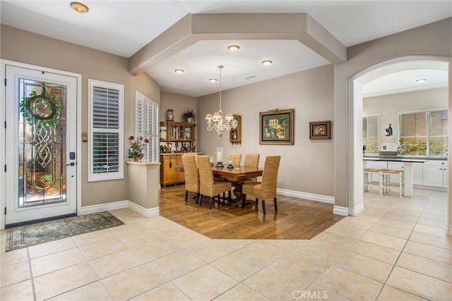 2012 Melbourne Cir, Banning, CA 92220 - dining area with arched walkways, light tile patterned floors, a chandelier, plenty of natural light, and recessed lighting