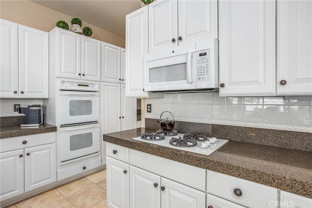 2012 Melbourne Cir, Banning, CA 92220 - kitchen with white appliances, dark countertops, white cabinetry, and tasteful backsplash