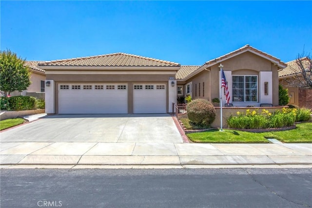 2012 Melbourne Cir, Banning, CA 92220 - view of front facade featuring stucco siding, an attached garage, driveway, and a tiled roof