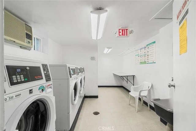 3605 W Hidden Ln Unit 112, Rolling Hills Estates, CA 90274 - shared laundry featuring washer and clothes dryer, a wall unit AC, baseboards, and light flooring