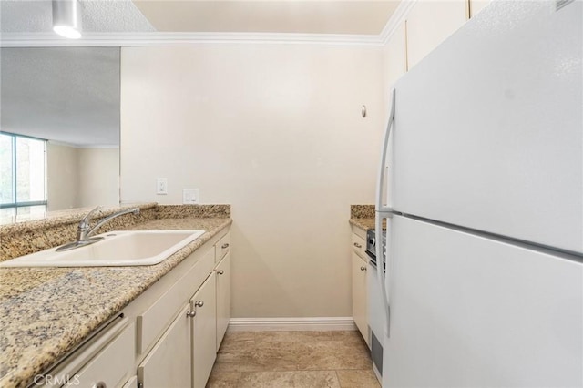 3605 W Hidden Ln Unit 112, Rolling Hills Estates, CA 90274 - kitchen with freestanding refrigerator, a sink, crown molding, and baseboards