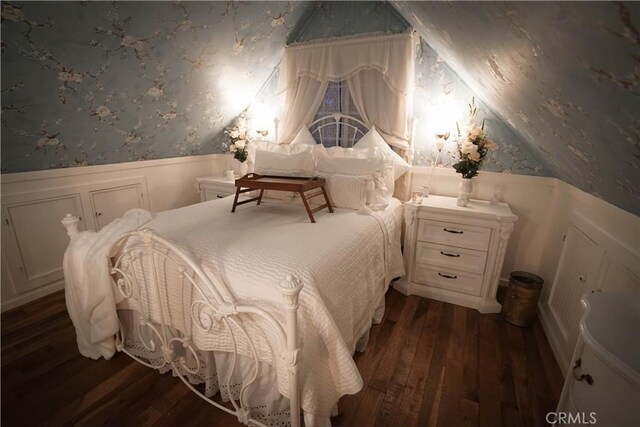 26335 Forest Ln, Twin Peaks, CA 92391 - bedroom featuring wallpapered walls, wainscoting, dark wood-style flooring, a decorative wall, and vaulted ceiling