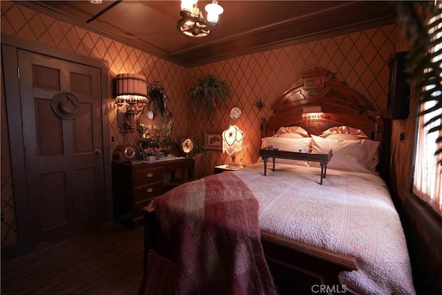 26335 Forest Ln, Twin Peaks, CA 92391 - bedroom with a chandelier, dark wood-type flooring, ornamental molding, and wallpapered walls