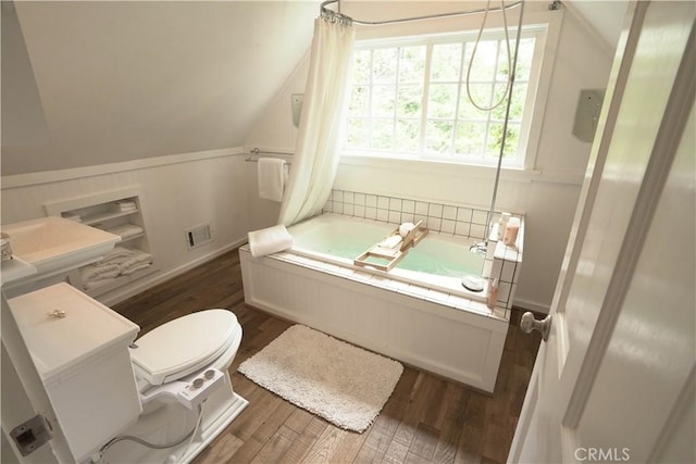 26335 Forest Ln, Twin Peaks, CA 92391 - bathroom with a garden tub, wood finished floors, vaulted ceiling, and a decorative wall