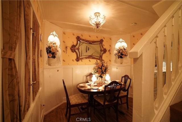 26335 Forest Ln, Twin Peaks, CA 92391 - dining room featuring a chandelier, wood finished floors, wainscoting, a decorative wall, and ornamental molding