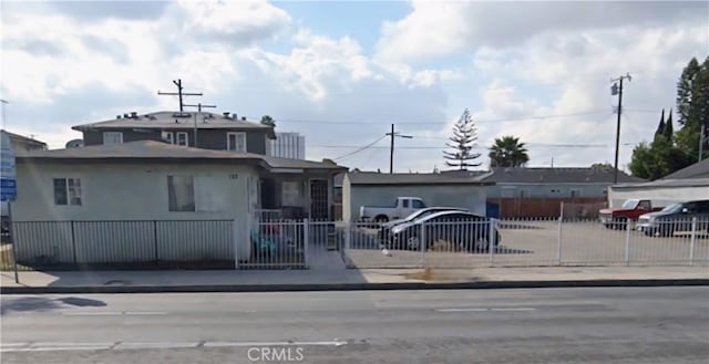 124 W Rosecrans Ave, Compton, CA 90222 - view of front of home with a fenced front yard and stucco siding