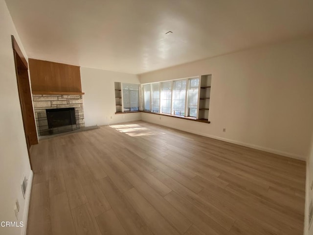 10315 Mcbroom St, Sunland, CA 91040 - unfurnished living room featuring wood finished floors, a fireplace, and baseboards