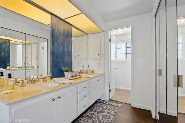 4354 Avenida Prado, Thousand Oaks, CA 91360 - full bathroom with double vanity, baseboards, toilet, and wood finished floors