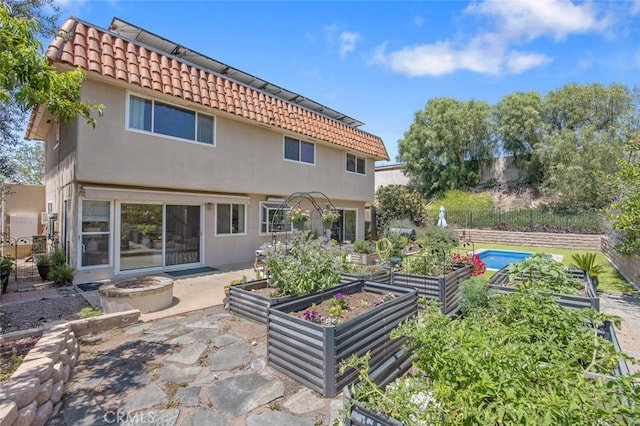 4354 Avenida Prado, Thousand Oaks, CA 91360 - rear view of house with a vegetable garden, a fire pit, stucco siding, a patio area, and a tiled roof