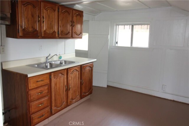 614 W 60th St, Los Angeles, CA 90044 - kitchen with a sink, light countertops, and brown cabinets