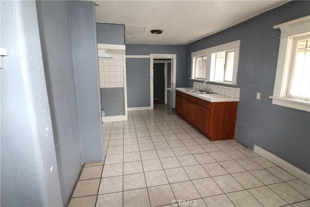 614 W 60th St, Los Angeles, CA 90044 - full bathroom with tile patterned floors, vanity, healthy amount of natural light, and baseboards