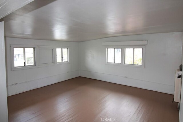 614 W 60th St, Los Angeles, CA 90044 - unfurnished room with wood finished floors and radiator