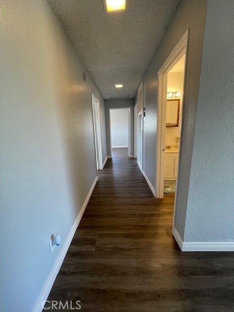 15577 Nisqualli Rd, Victorville, CA 92395 - hall with dark wood-style floors, a textured ceiling, and a textured wall