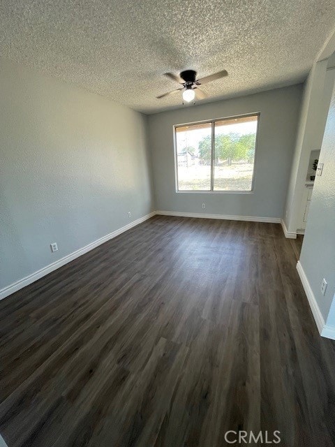 15577 Nisqualli Rd, Victorville, CA 92395 - empty room featuring dark wood finished floors, a textured ceiling, and a ceiling fan