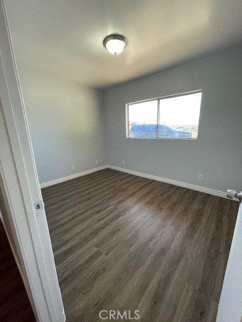 15577 Nisqualli Rd, Victorville, CA 92395 - spare room featuring dark wood-style flooring