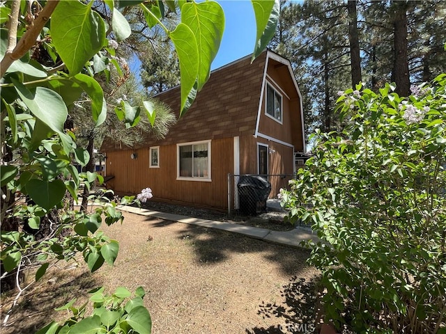 2076 8th Ln, Big Bear City, CA 92314 - view of side of property featuring a gambrel roof and a shingled roof