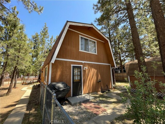 2076 8th Ln, Big Bear City, CA 92314 - rear view of property featuring a gambrel roof and an outbuilding
