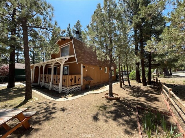 2076 8th Ln, Big Bear City, CA 92314 - view of side of property featuring roof with shingles