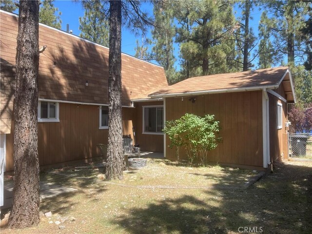 2076 8th Ln, Big Bear City, CA 92314 - back of house with a shingled roof and cooling unit
