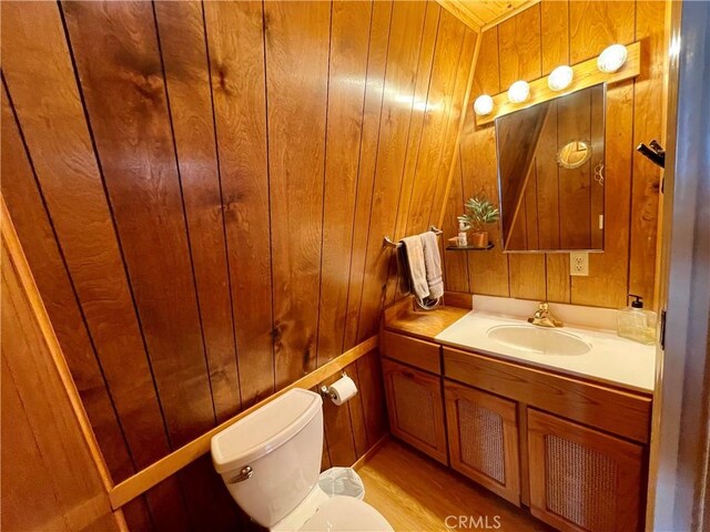 2076 8th Ln, Big Bear City, CA 92314 - half bathroom featuring toilet, vanity, and wooden walls