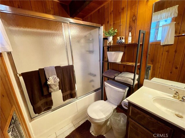 2076 8th Ln, Big Bear City, CA 92314 - full bathroom with wooden walls, vanity, tile patterned flooring, enclosed tub / shower combo, and toilet