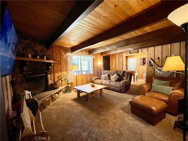 2076 8th Ln, Big Bear City, CA 92314 - living room with wood walls, carpet flooring, wooden ceiling with exposed beams, and a fireplace