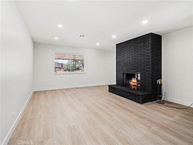 38537 Desert View Dr, Palmdale, CA 93551 - unfurnished living room with a fireplace, light wood-type flooring, recessed lighting, and baseboards
