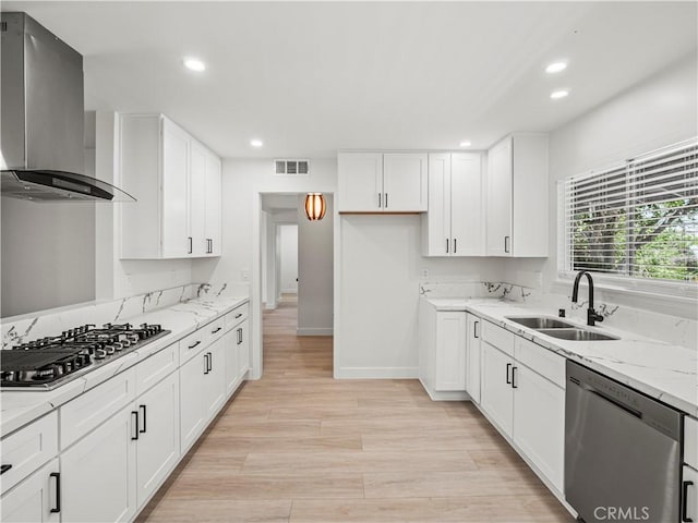 38537 Desert View Dr, Palmdale, CA 93551 - kitchen with appliances with stainless steel finishes, wall chimney range hood, a sink, recessed lighting, and light wood-style flooring