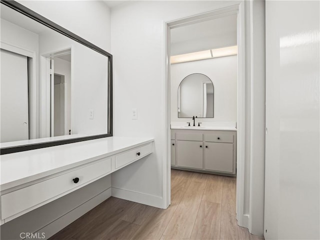 38537 Desert View Dr, Palmdale, CA 93551 - bathroom featuring wood finished floors, vanity, and baseboards