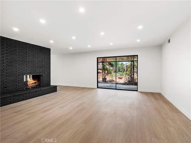 38537 Desert View Dr, Palmdale, CA 93551 - unfurnished living room with light wood finished floors, baseboards, recessed lighting, and a fireplace