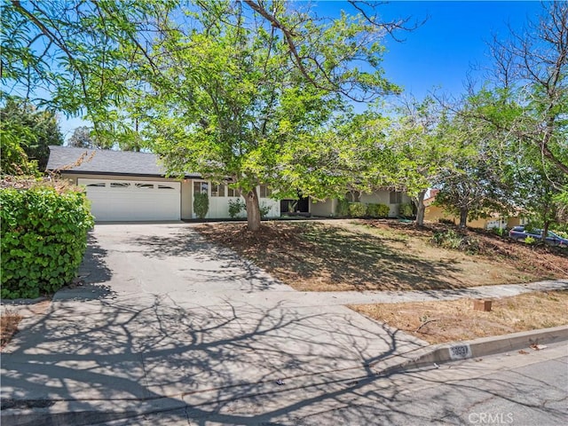 38537 Desert View Dr, Palmdale, CA 93551 - view of property hidden behind natural elements with asphalt driveway, an attached garage, and stucco siding