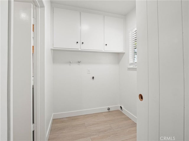 38537 Desert View Dr, Palmdale, CA 93551 - washroom featuring cabinet space, light wood-type flooring, baseboards, and electric dryer hookup